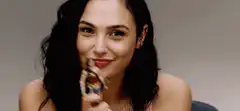 Gal Gadot holds Wonder Woman action figure