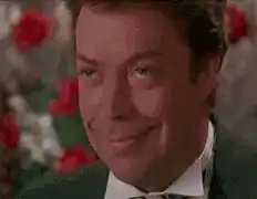 Tim Curry smiling and laughing