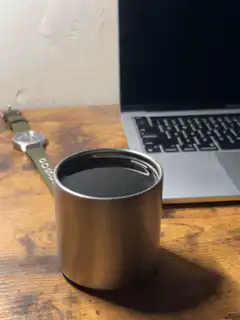 Coffee cup on desk with laptop