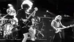 AC/DC Angus Young playing guitar on stage
