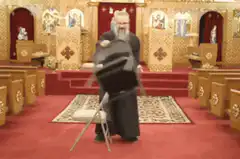 Orthodox priest flips chair