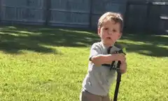 Toddler gets sprayed in the face by a hose
