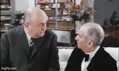 Two men talking on a couch