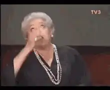 Elderly woman facepalms in disbelief