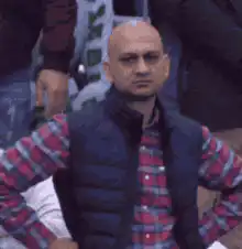 Bald man in vest looks around