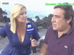 Reporter leans in to interview man