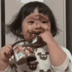 Toddler eating Nutella with messy face