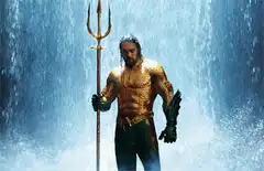 Aquaman holding trident in waterfall