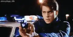 Ray Liotta pointing gun at night