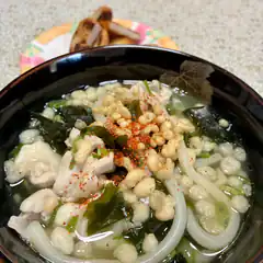 Bowl of Japanese udon soup with chicken and tempura bits