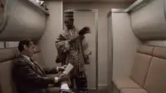 Man in robe waving feather on plane