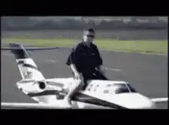 man riding toy airplane on runway