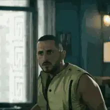 Man in vest looking around confused