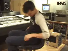 Man spinning in office chair in studio