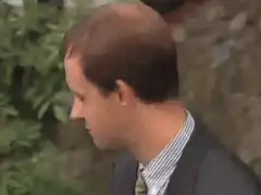 Man turns head and makes a funny face