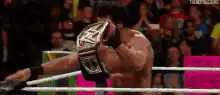 Seth Rollins raises WWE championship belt