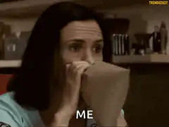 Woman breathing into paper bag