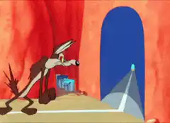 Wile E. Coyote crashes through a rock wall