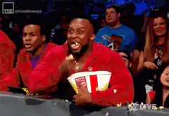 Bored man eats popcorn at WWE