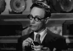 Leslie Howard sipping tea with pipe
