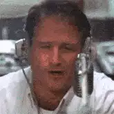 Harrison Ford singing into a microphone