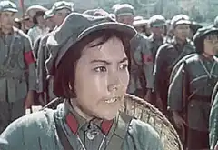 Female soldier saluting with troops