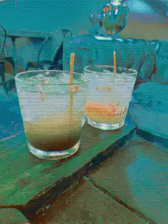Two drinks with straws on a table