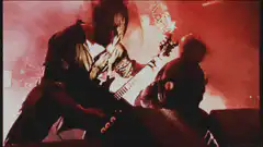 guitarist playing on stage with red lights
