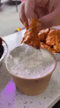 Buffalo wing dipped in ranch dressing