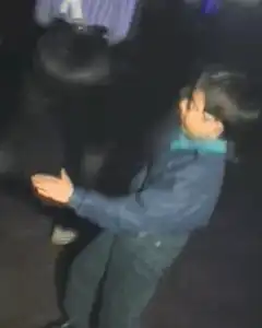 kid dancing in blue jacket