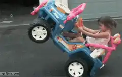 Toddler riding toy car on two wheels