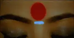 Woman's eyes glow with trident symbol