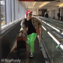 Man in bright green pants and leopard print jacket on moving walkway