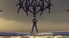 Soldiers forming a pyramid on a plane wing