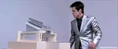 Man in silver suit breaks a model house