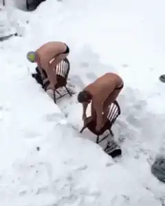 Two men diving into deep snow