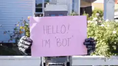 Robot holding hello sign