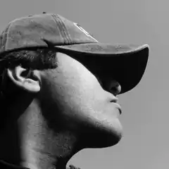 Man in cap looking up
