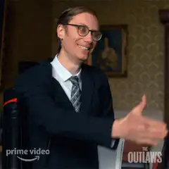 Man in suit gives thumbs up