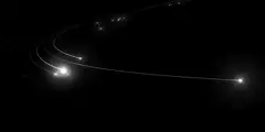 Abstract white light trails on black background
