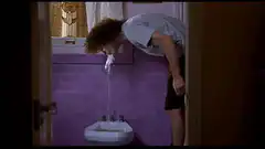 Man spitting water into sink
