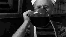 Old man drinking from a jug