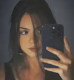 Woman taking mirror selfie with phone