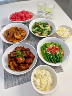Chinese home-cooked meal with shrimp, pork, okra, and watermelon