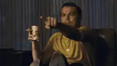 Leonardo DiCaprio pointing with coffee mug