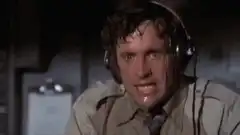 Man sweating and wiping his forehead