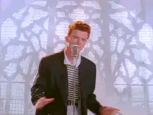 Rick Astley singing into a microphone