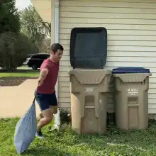Man kicks trash can lid