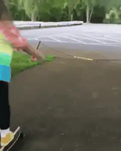 girl on skateboard hits rope and falls