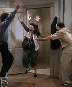 Woman jumping through doorway with arms raised